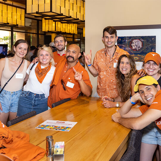 Smiling alumni in University of Texas gear