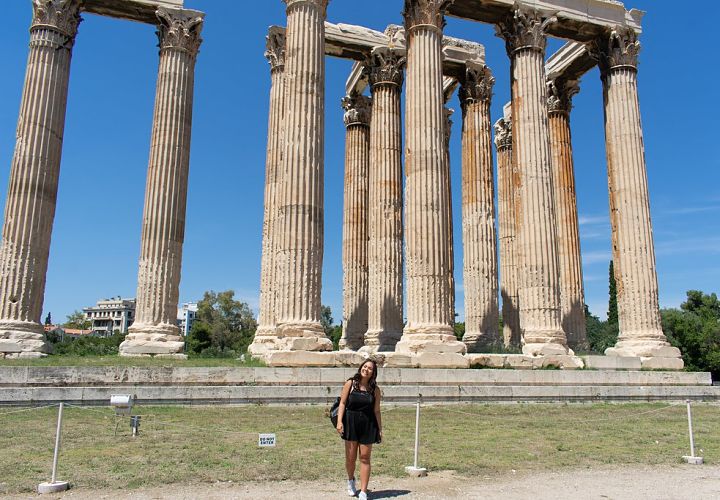 Study abroad student stands in front of ruins in Athens