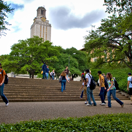 Students walking on stairs in front of University of Texas tower
